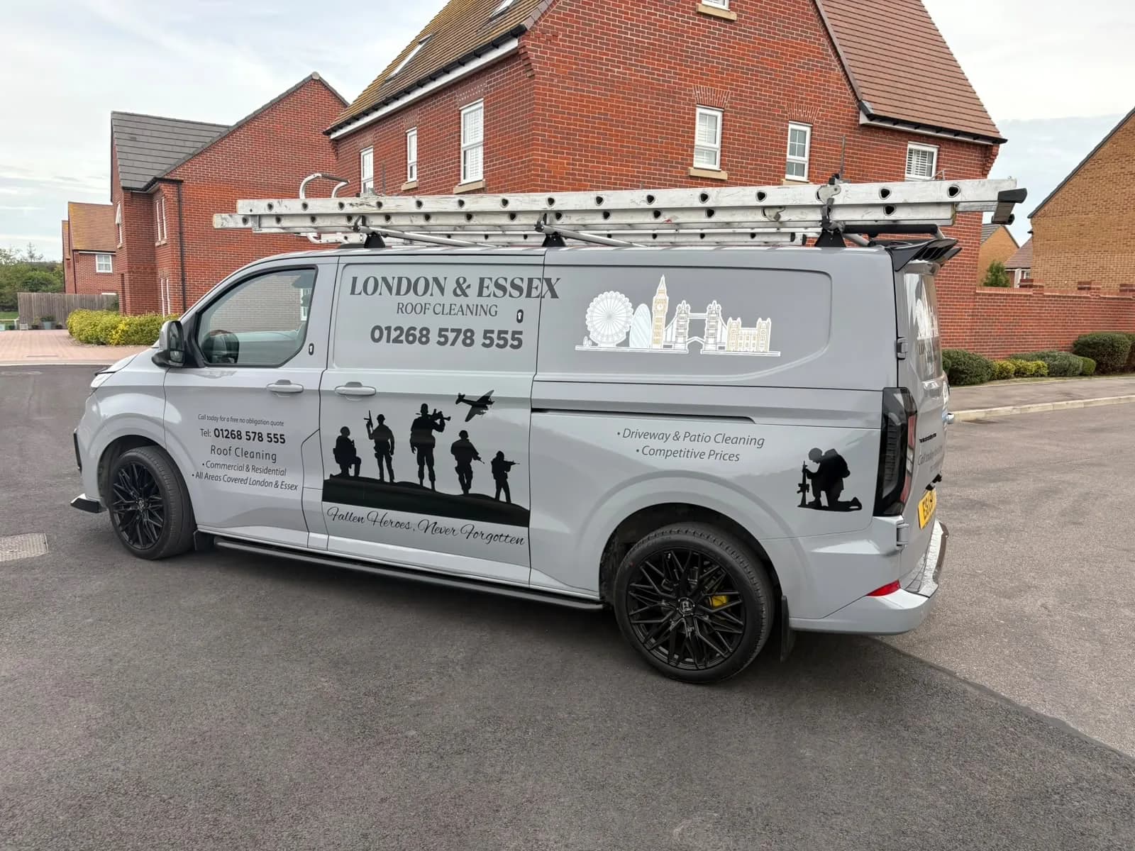 The London & Essex Roof Cleaning van parked outside a house, ladders on the roof