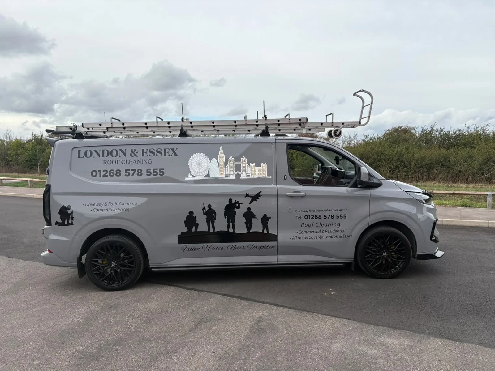 Side of the London & Essex Roof Cleaning van with the name, phone number and soldier silhouettes
